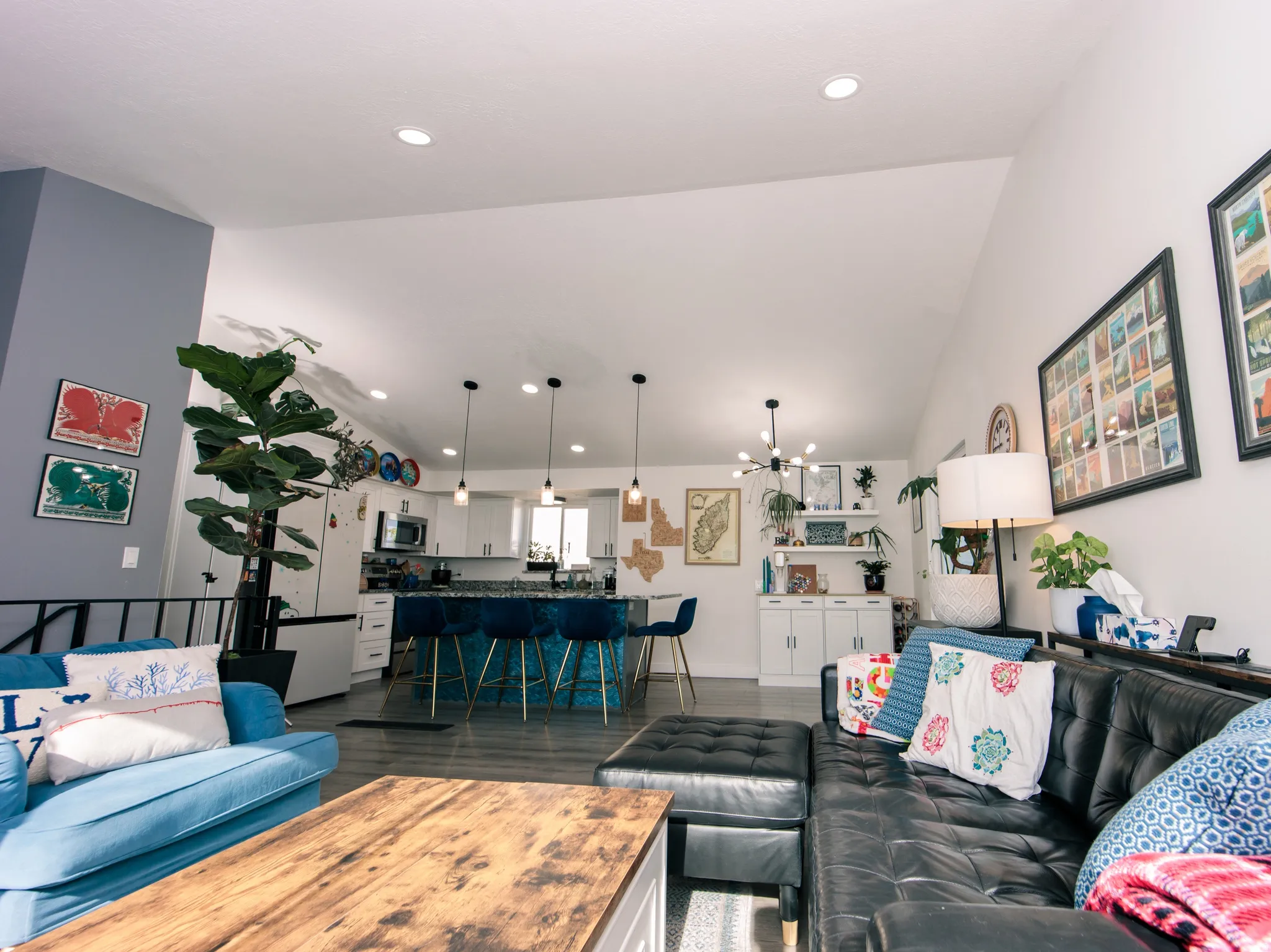 Vaulted ceilings enhance this open-concept living space, featuring recessed lighting and wood-finish flooring