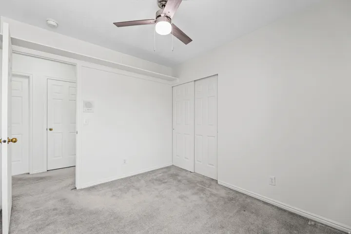 Carpeted interior space featuring white walls and trim