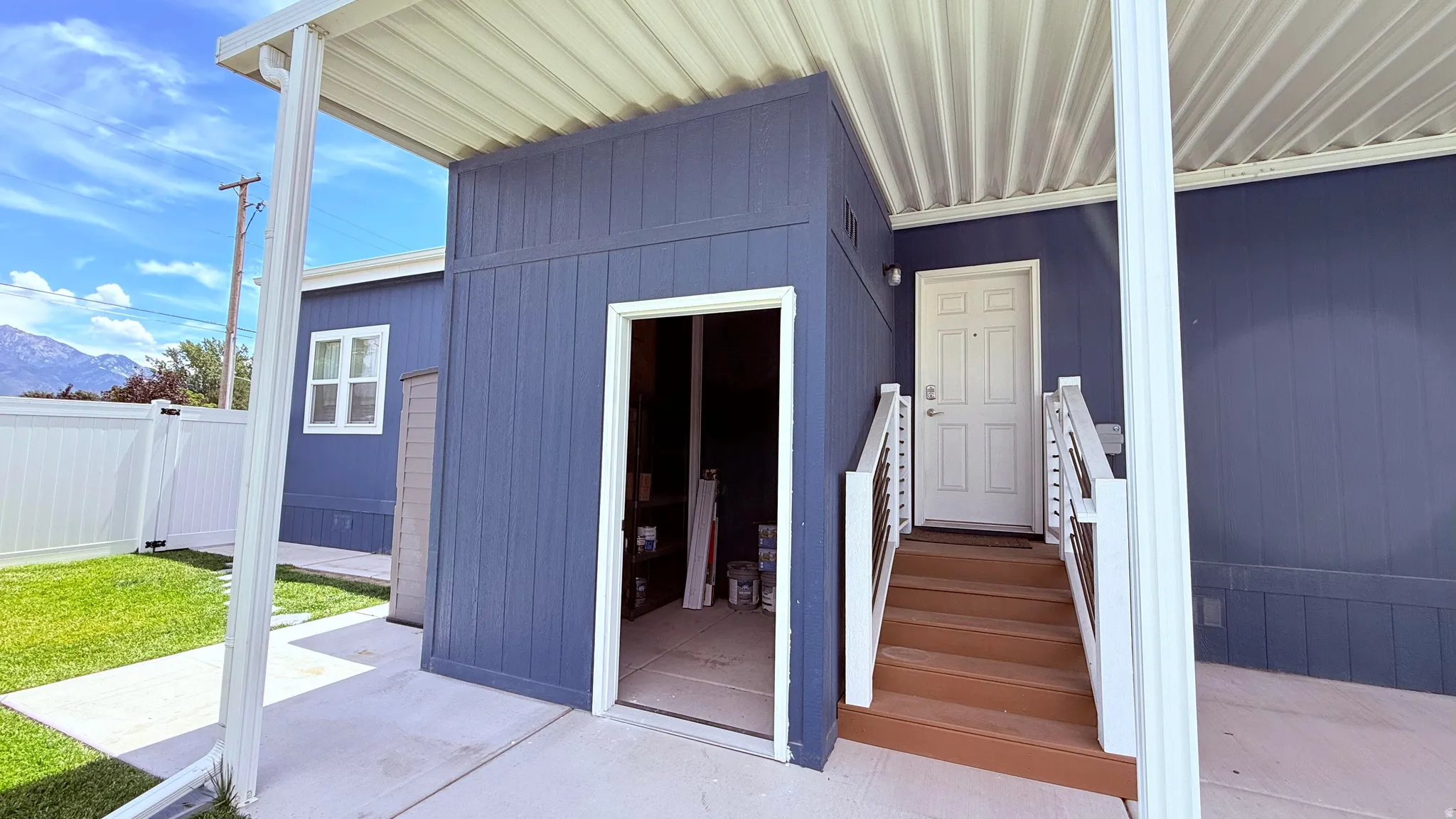 Attached storage shed and side entrance