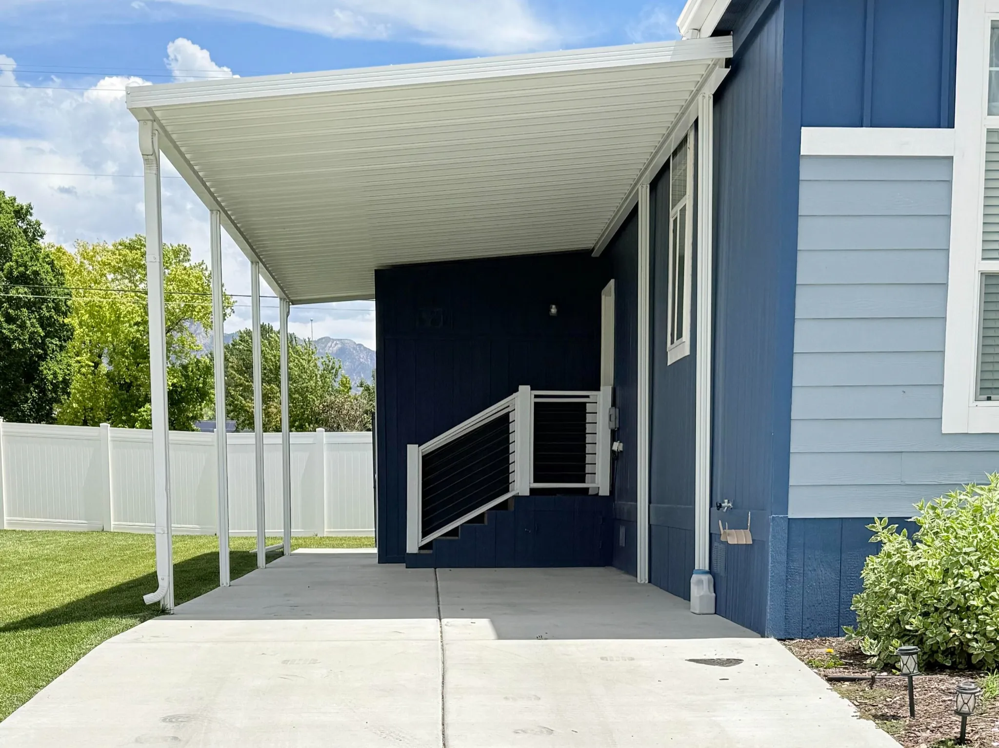 Covered carport with concrete paving