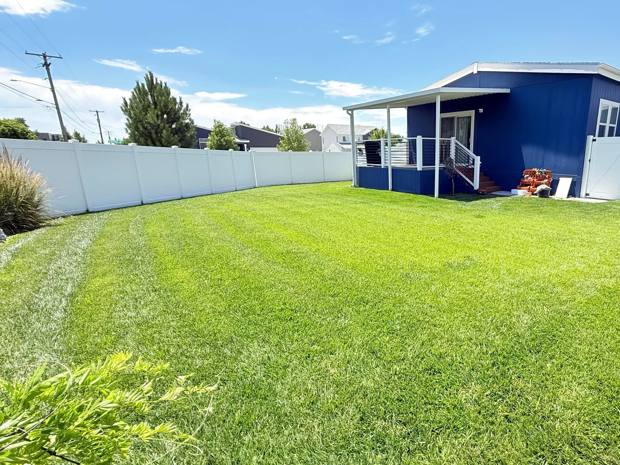 Expansive green lawn with full perimeter fencing