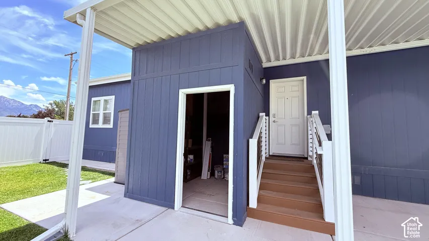 Attached storage shed and side entrance