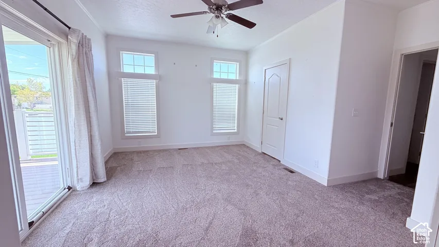 Primary Bedroom with brand new carpet, access to back covered deck and yard