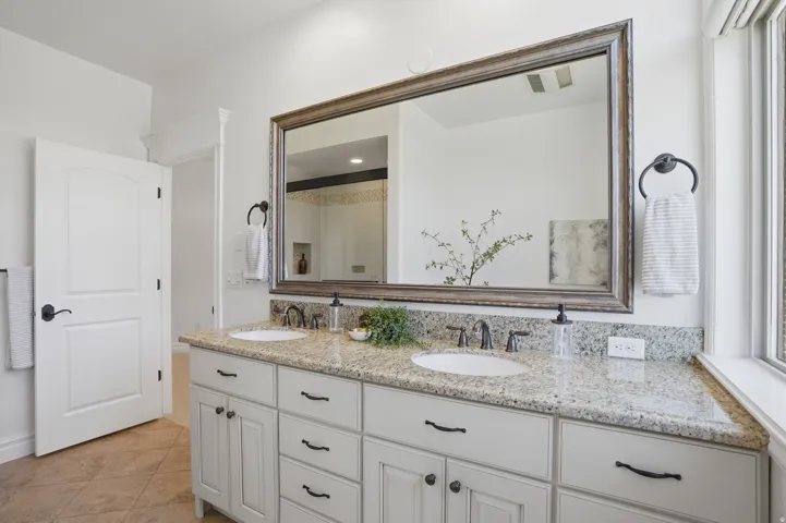 Double vanity with granite countertop and integrated sinks