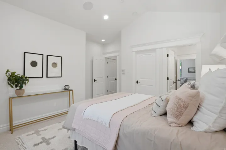 Bright room featuring an angled ceiling, recessed lighting, and a neutral color palette