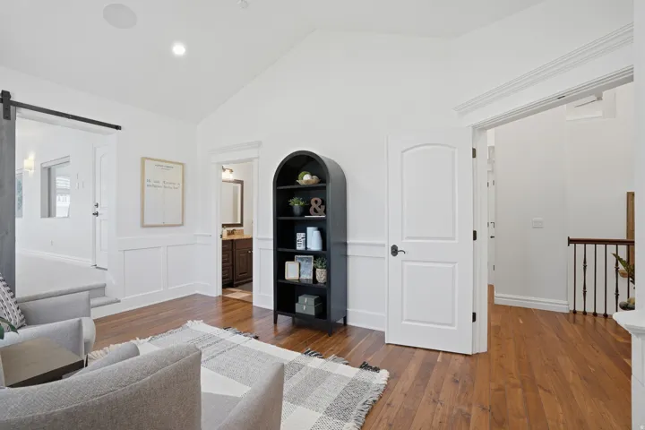 Vaulted white ceilings featuring recessed lighting and integrated audio speakers
