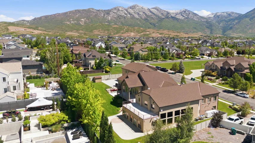 Expansive residential property featuring a multi-level design, multiple outdoor patios, and mature landscaping