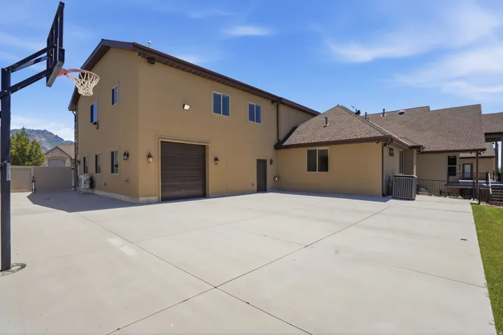 Expansive concrete pad featuring a basketball hoop