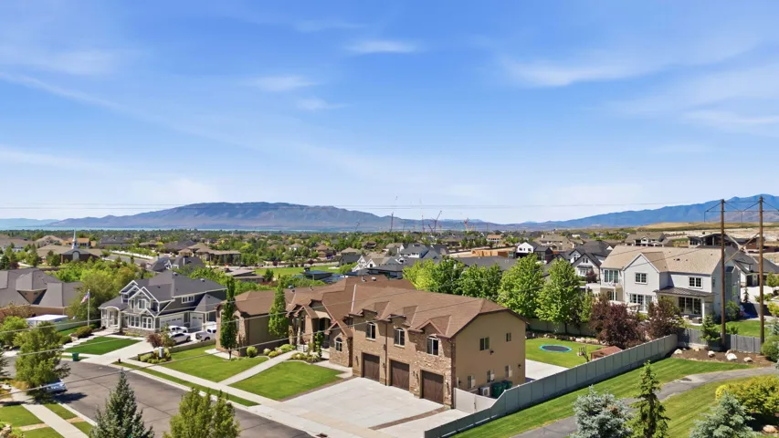 Expansive suburban neighborhood with mountain scenery and distant water body