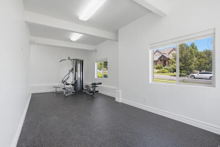 Dedicated exercise room featuring resilient dark-toned flooring