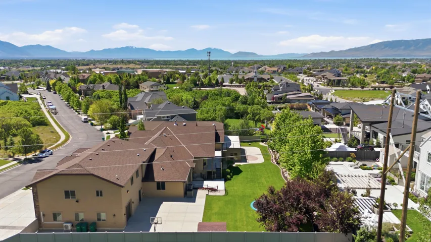 Expansive property featuring a large, manicured lawn and a spacious paved area