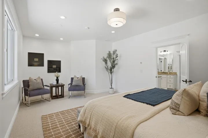 Bedroom with light-toned carpet flooring, recessed lighting, and a contemporary ceiling fixture