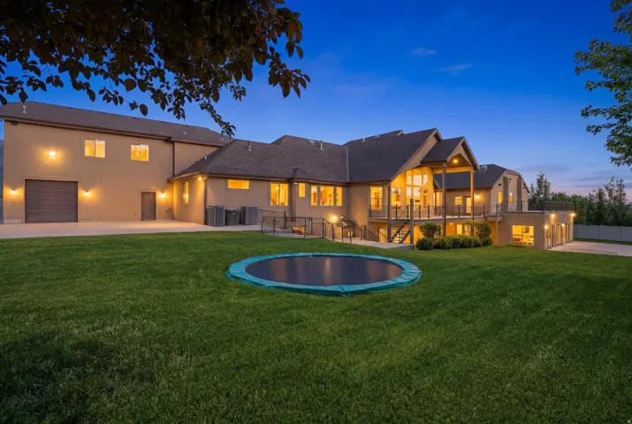 Spacious property featuring a large rear exterior, multi-level deck, and extensive lawn