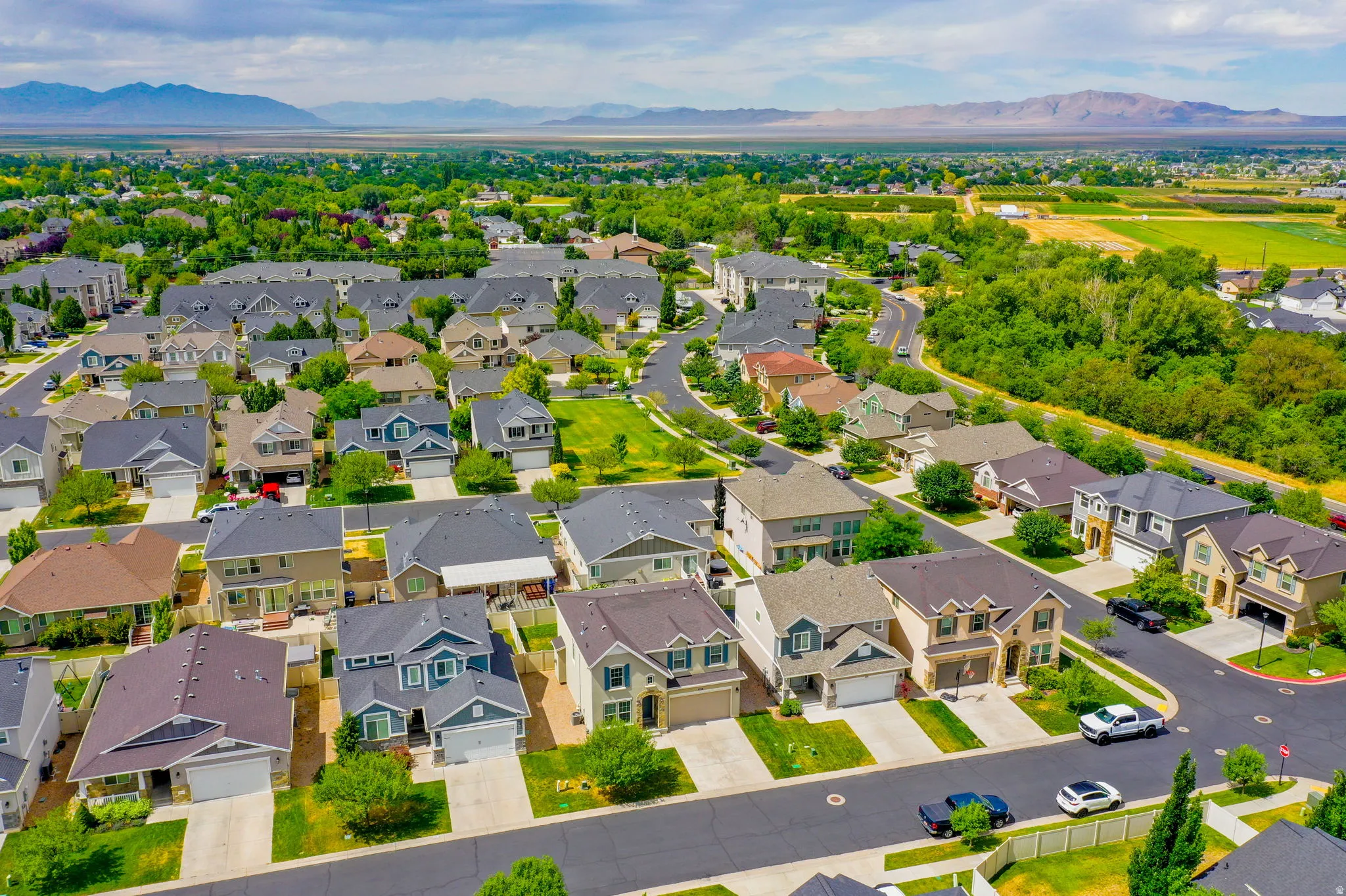 Expansive residential area featuring numerous single-family homes, mature landscaping, and curved streets