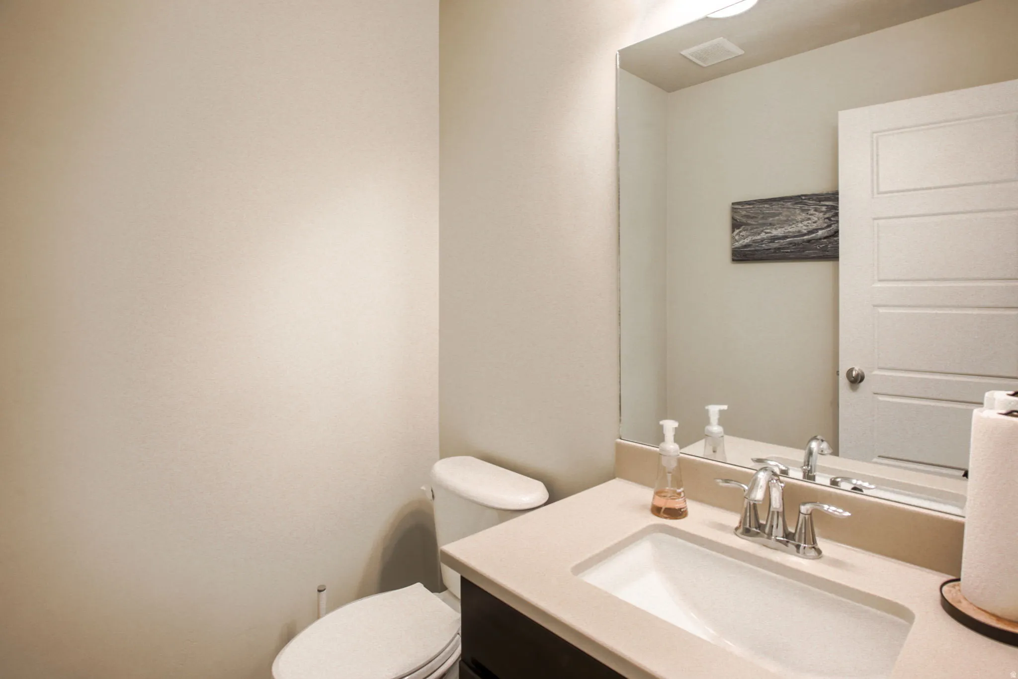 Contemporary vanity with an integrated rectangular sink, light-toned countertop, and chrome faucet