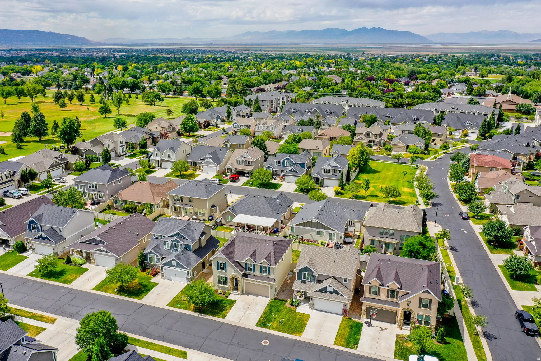 Residential neighborhood featuring a variety of single-family homes, mature landscaping, and paved streets