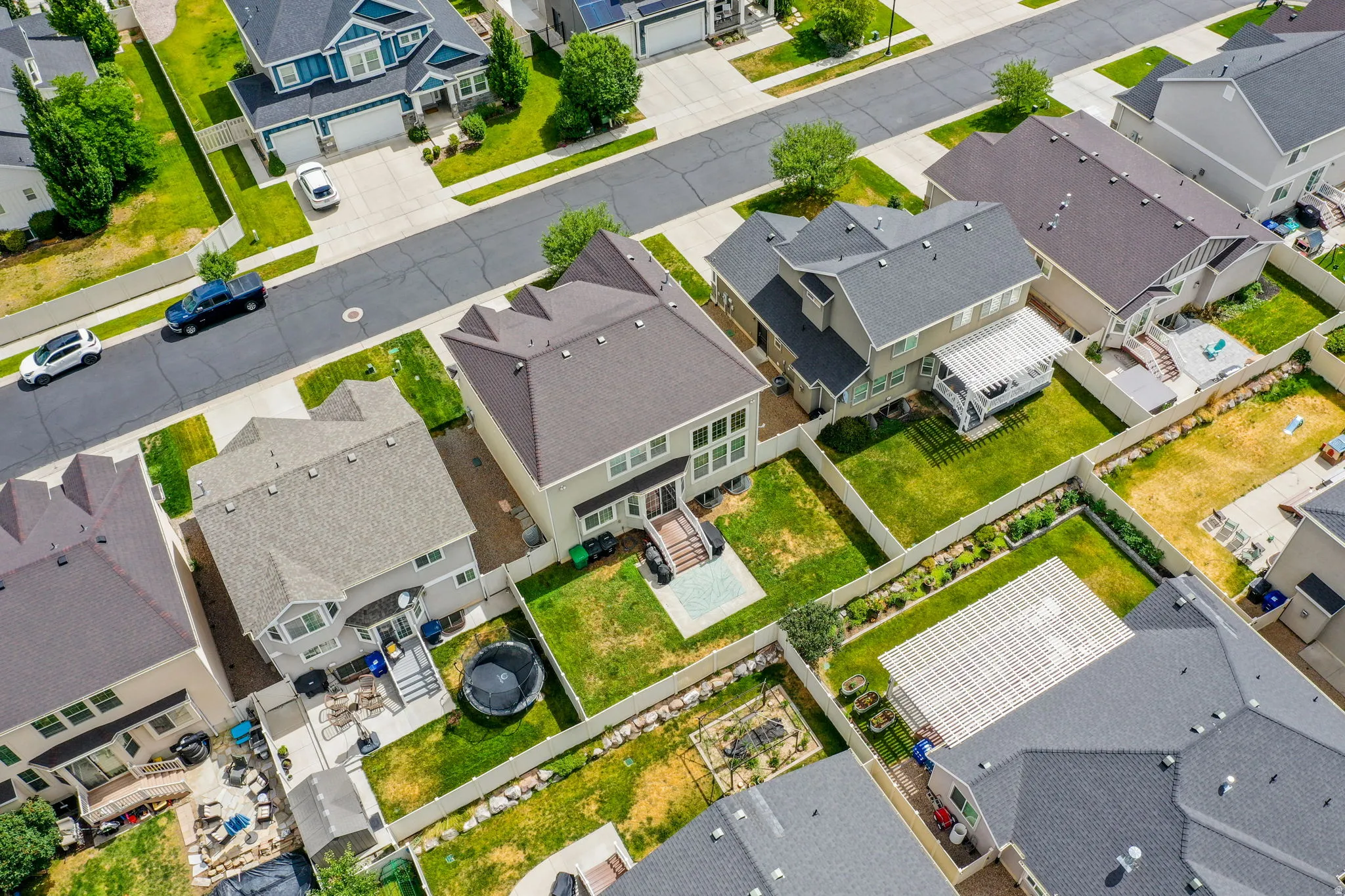 Aerial view of a residential neighborhood featuring asphalt streets and concrete sidewalks