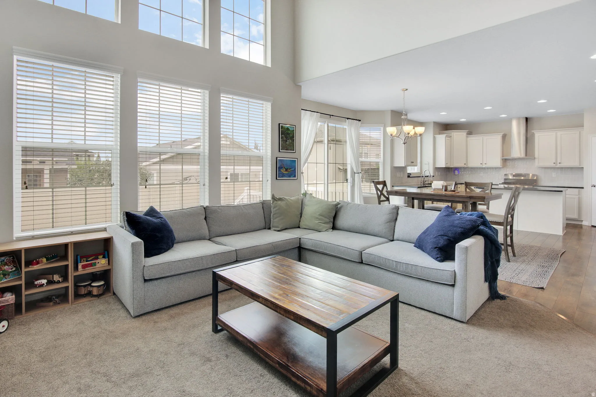 Open-concept living space featuring high ceilings and abundant natural light