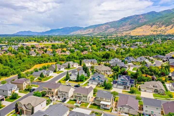 Expansive residential area featuring numerous single-family homes, mature trees, and paved streets