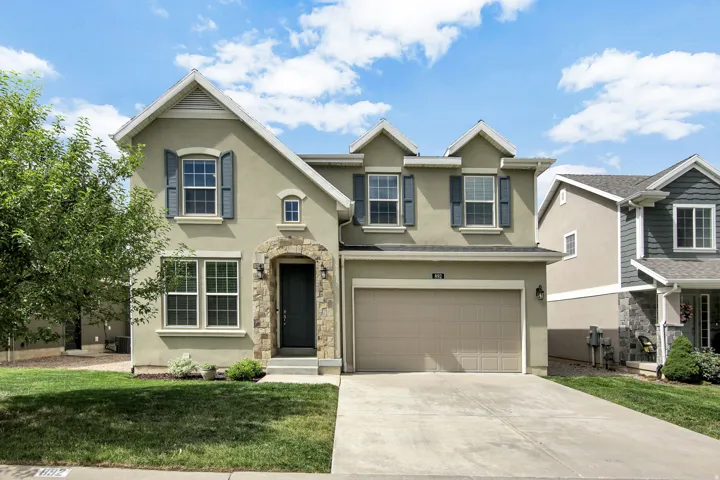Stucco exterior with stone accent archway around the front entry