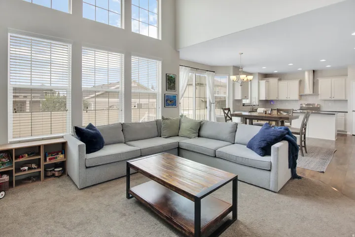 Open-concept living space featuring high ceilings and abundant natural light