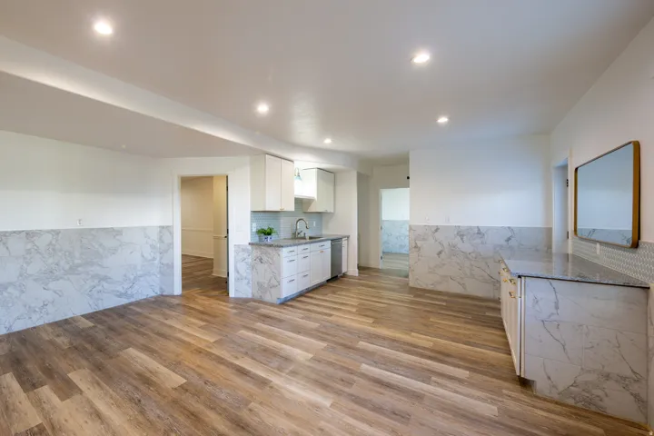 Open-concept space featuring wood-finish flooring, recessed lighting, and white walls