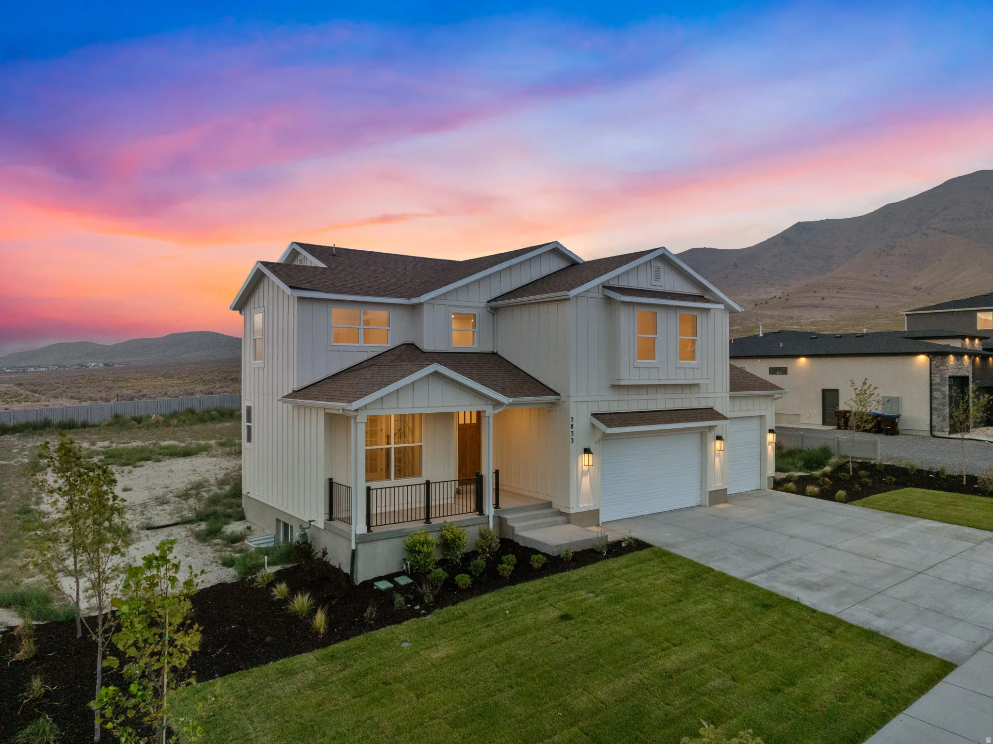 Farmhouse-style featuring front yard landscaping.  View from the southwest corner of property.