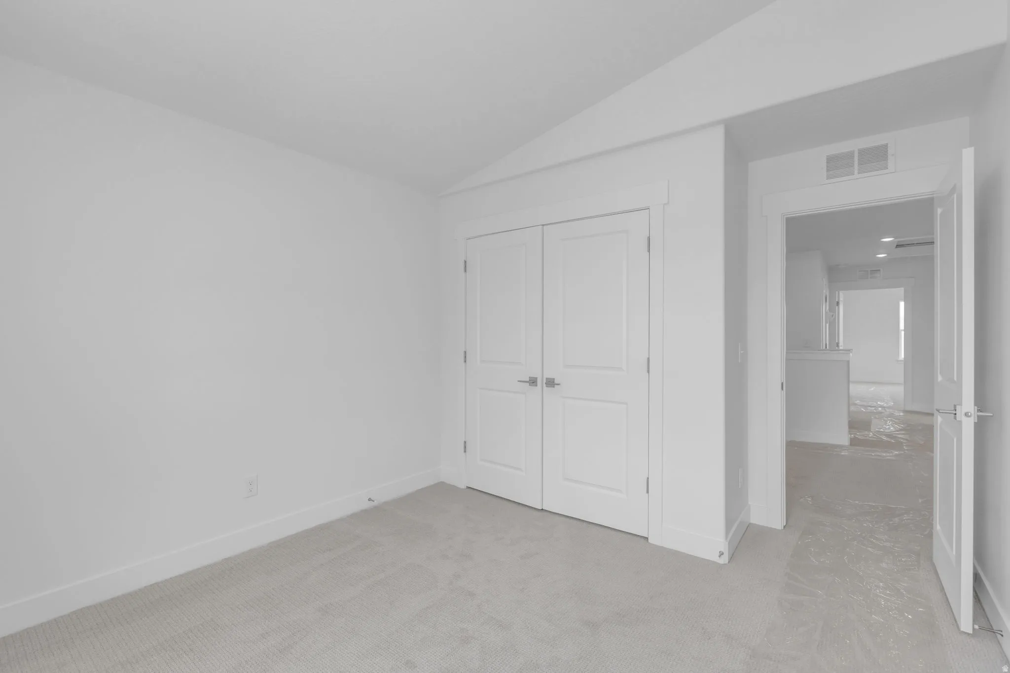 Vaulted bedroom #3 with double-door closet.