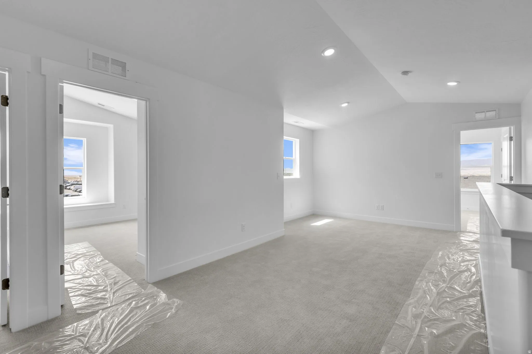 Vaulted loft area at top of stairs with four bedrooms flowing off this open space.