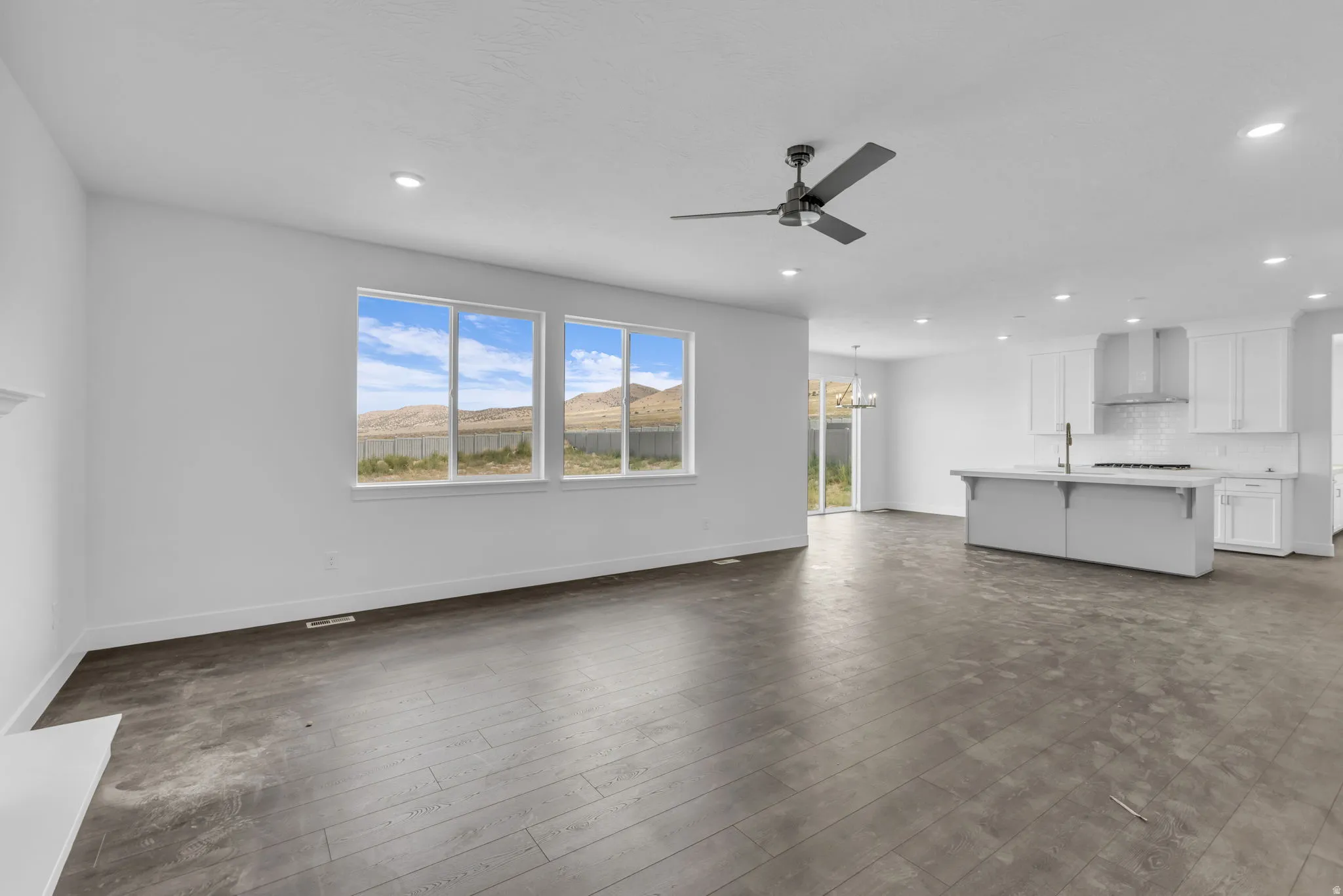 Open-concept living area with large windows to mountain views.