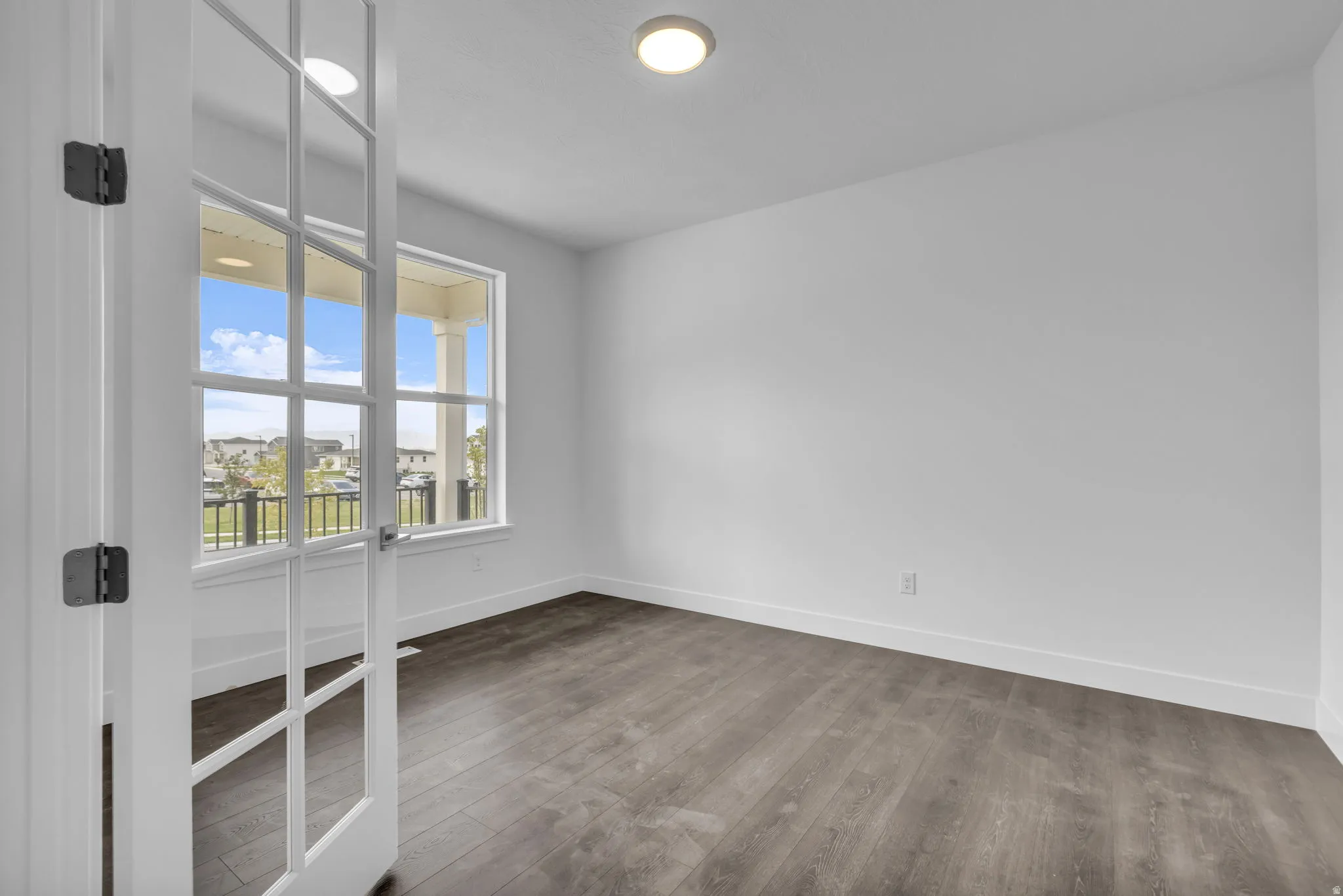 Flex space or office space off the entry featuring large windows with lots of natural light.