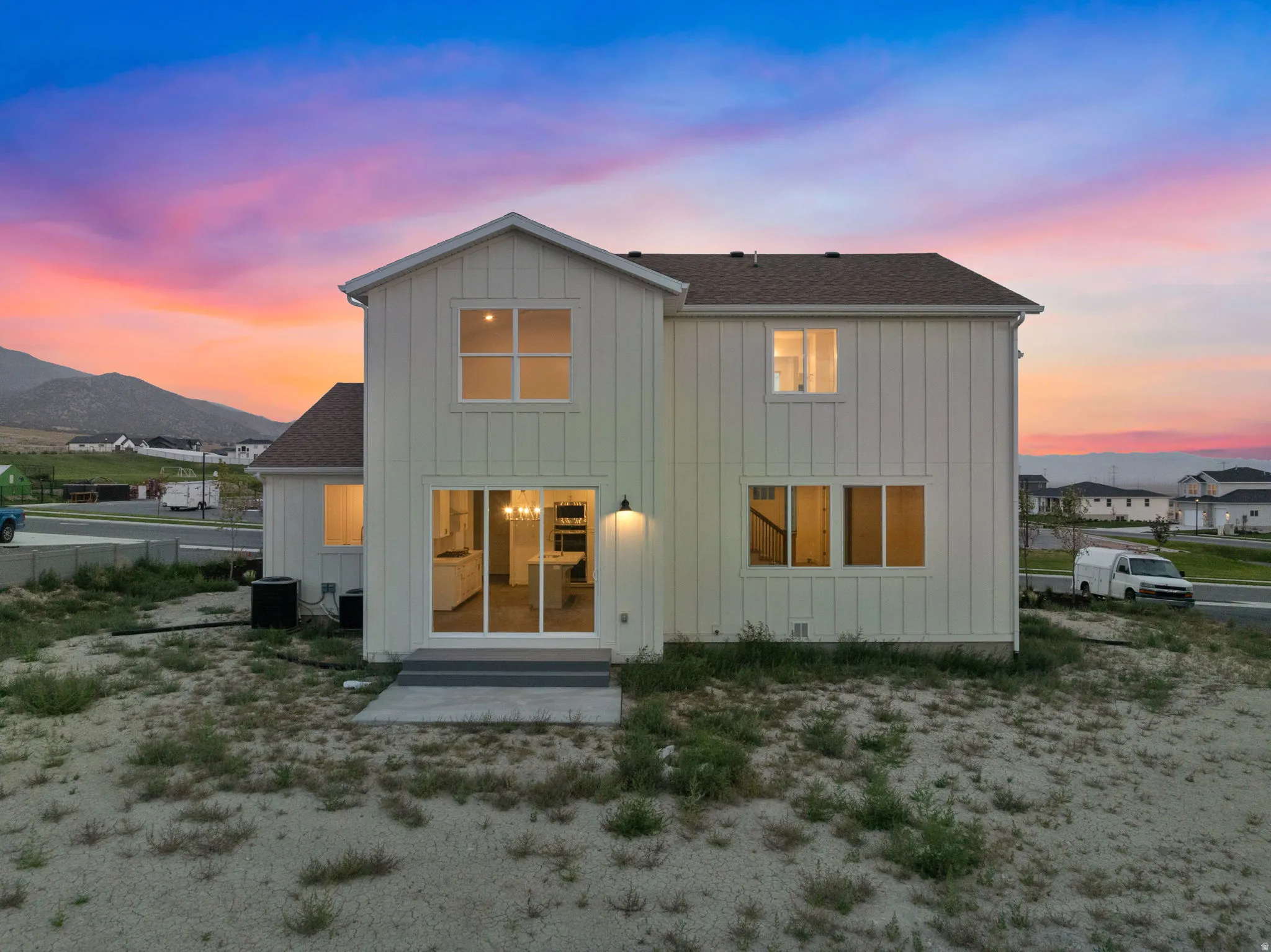 Rear view of home taken from the north side of home.  Large half acre lot with beautiful mountain views.  Large three panel slider for great views from the home.