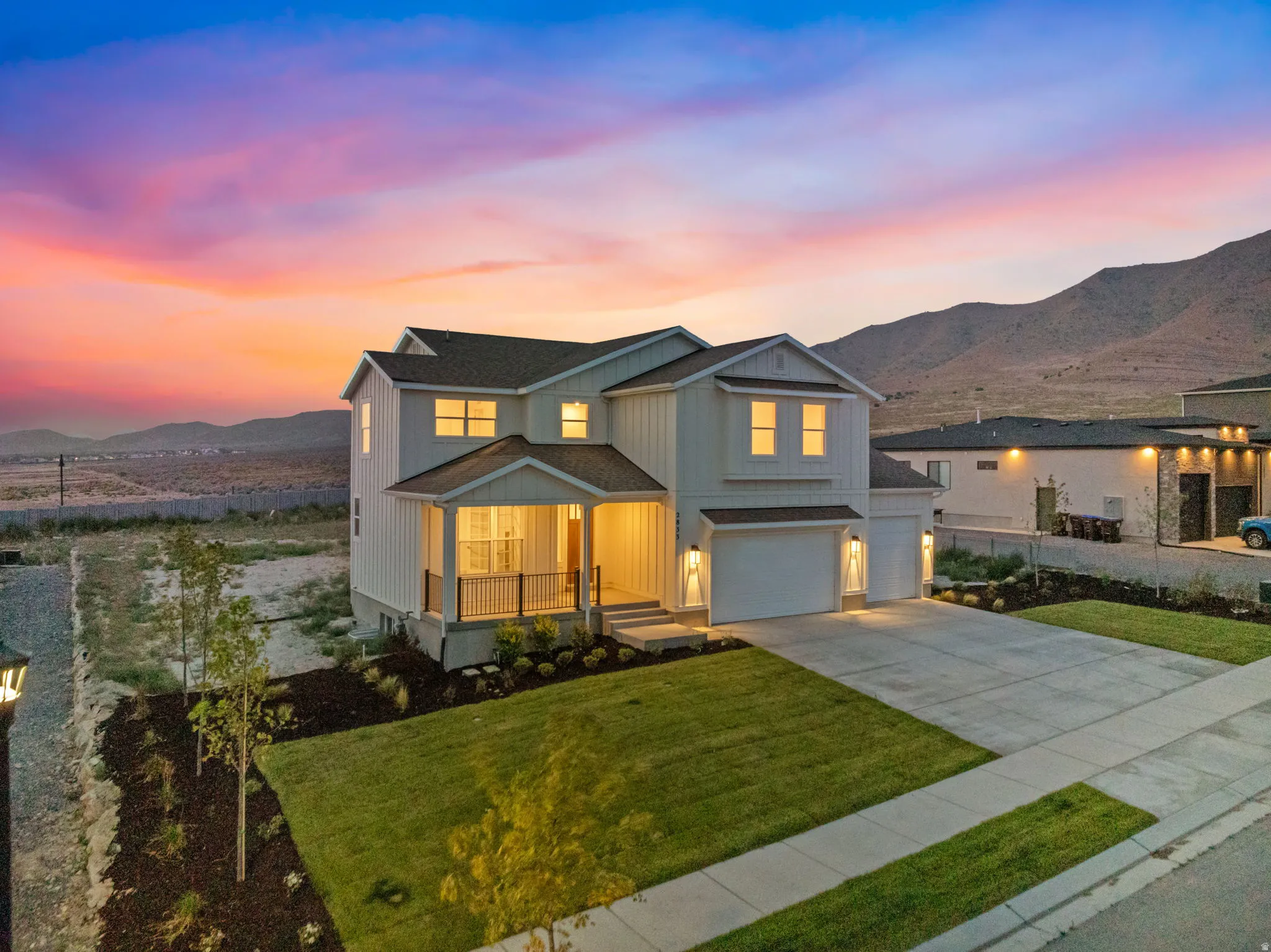 Farmhouse style two-story home on a half acre lot. Picture from the southwest corner at sunset.