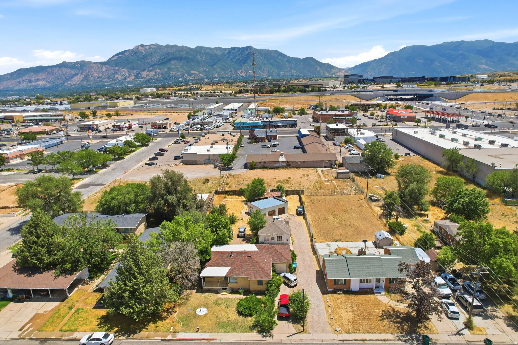 Aerial perspective showcasing a residential area with varied housing styles and mature trees