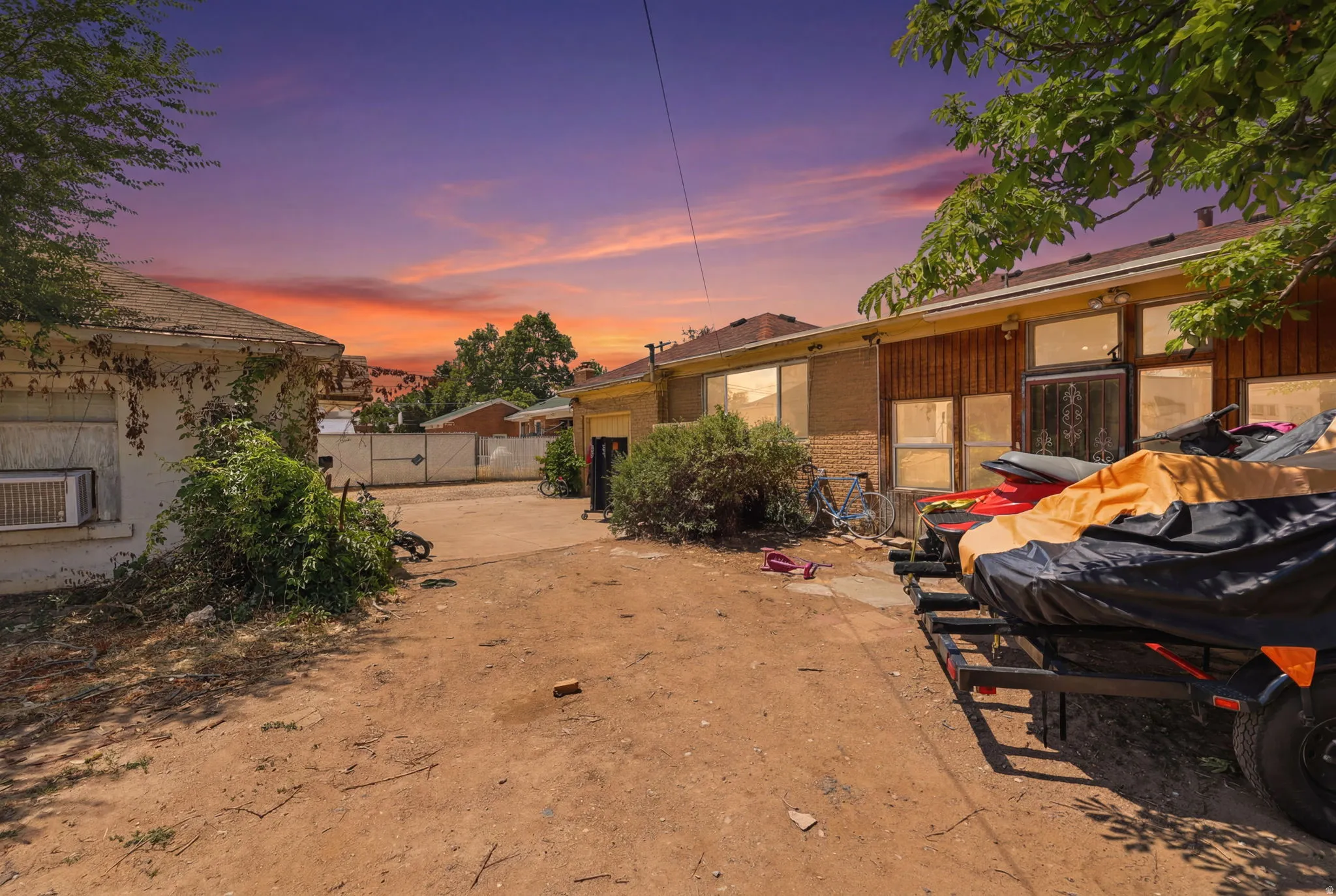 Expansive lot featuring a dirt surface and mature trees