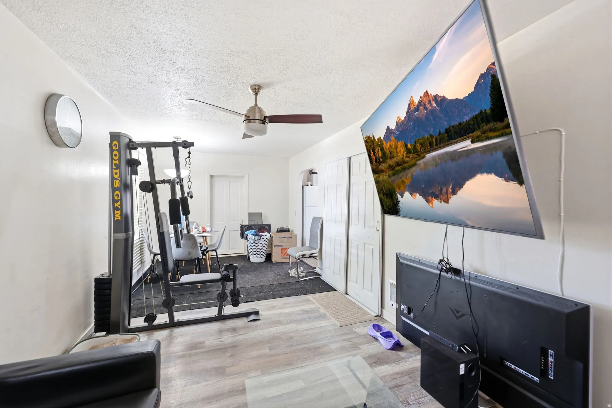 Open concept living space featuring wood-finish flooring and a ceiling fan