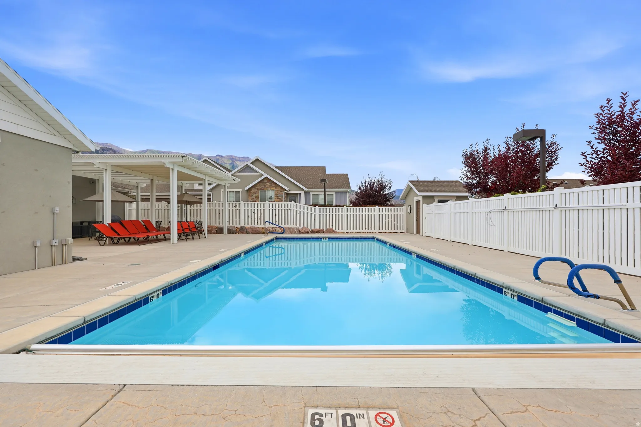 Rectangular swimming pool surrounded by a concrete deck