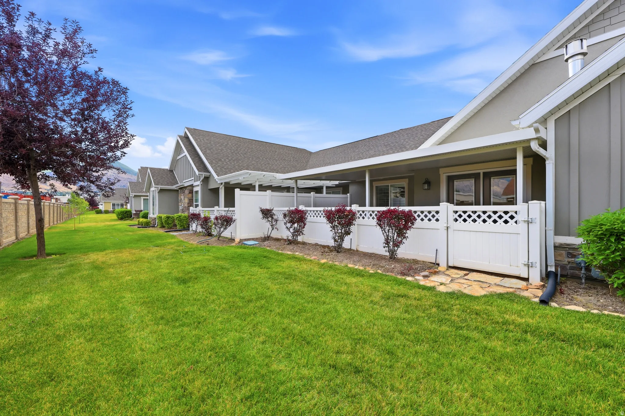 Expansive green lawn with mature landscaping