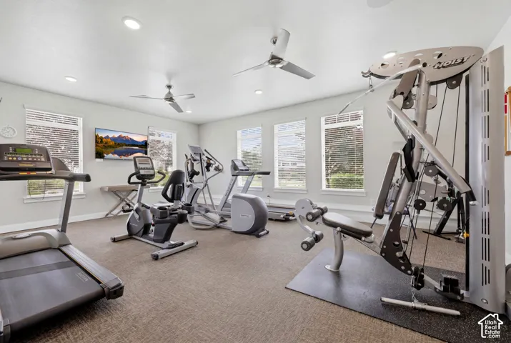 Dedicated fitness room featuring multiple windows, recessed lighting, and two ceiling fans
