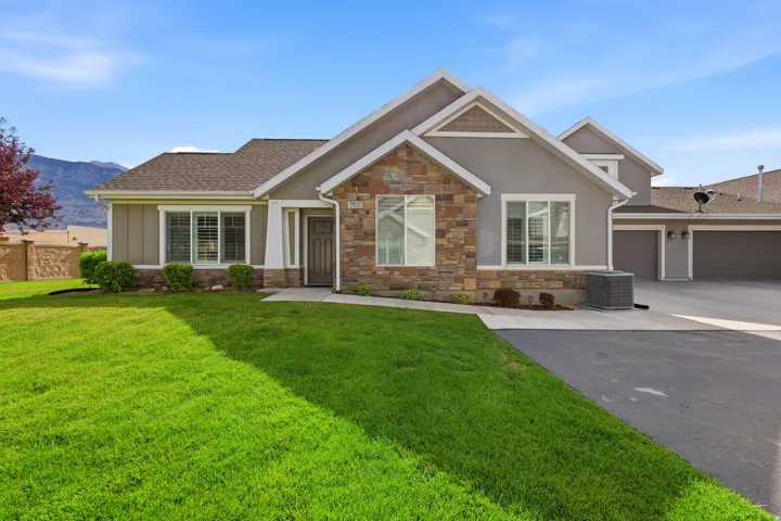 Exterior facade featuring stone and stucco finishes