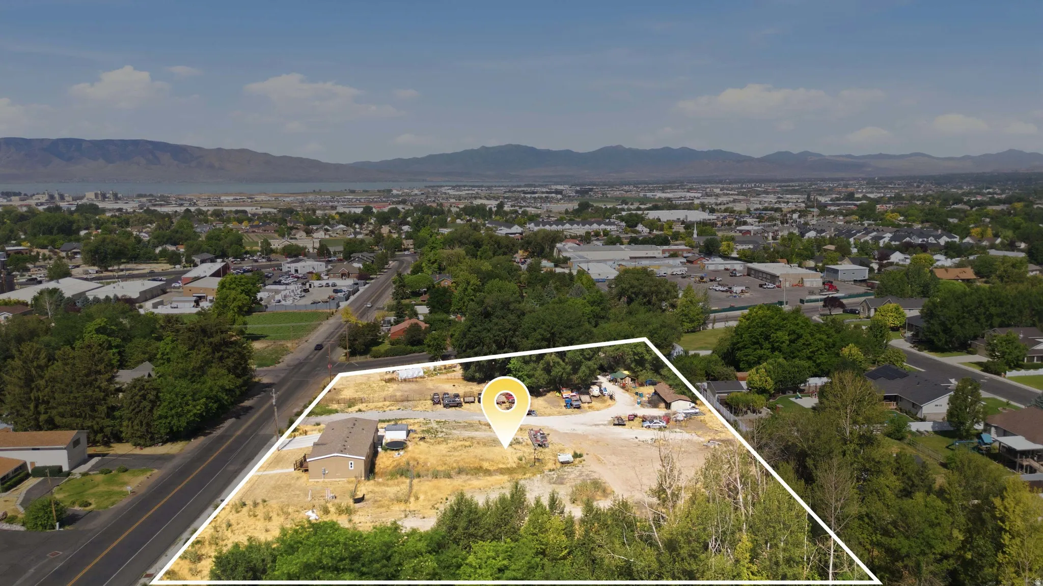 Aerial perspective showcasing a large parcel of land with a single-story structure
