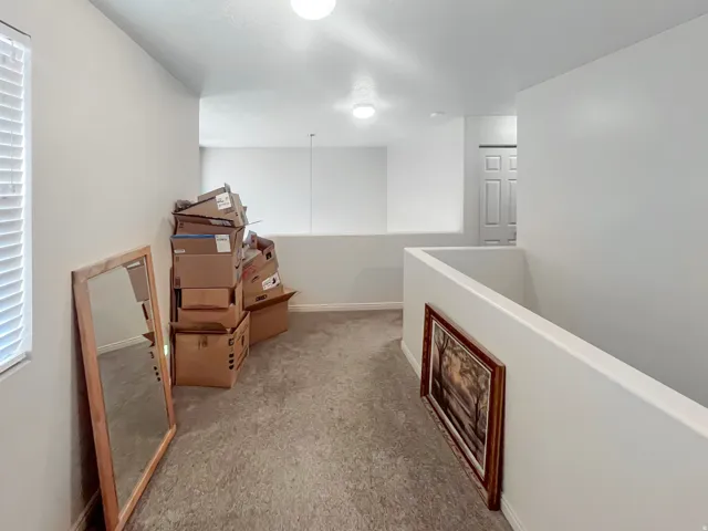 Spacious hallway that provides enough room for a cozy study and a look over the family room