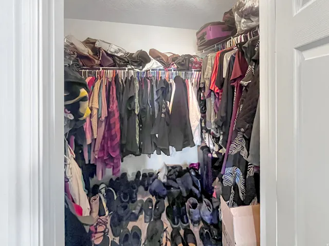 Primary bedroom walk-in closet and warm, natural light in the bedroom