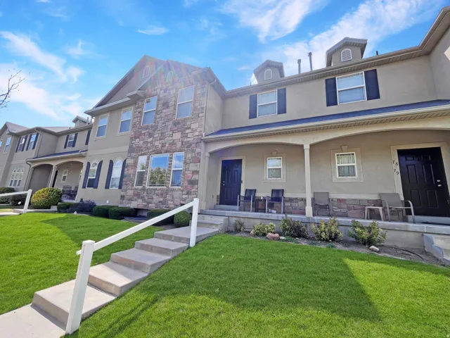 Classic, maintenance-free exterior featuring clean stucco with just the right blend of stone and an inviting front porch.