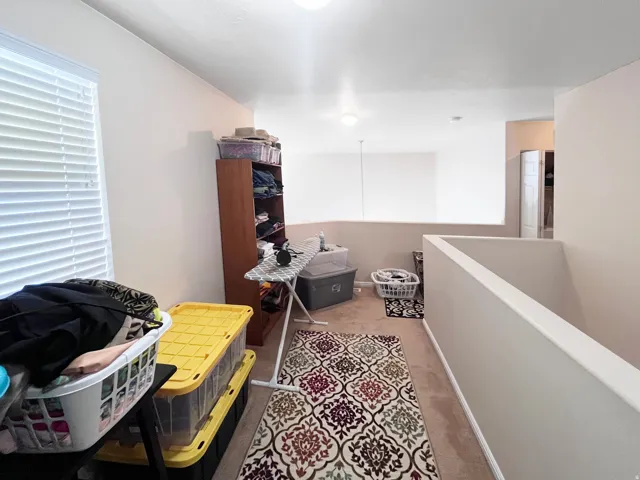 Spacious hallway that provides enough room for a cozy study and a look over the family room