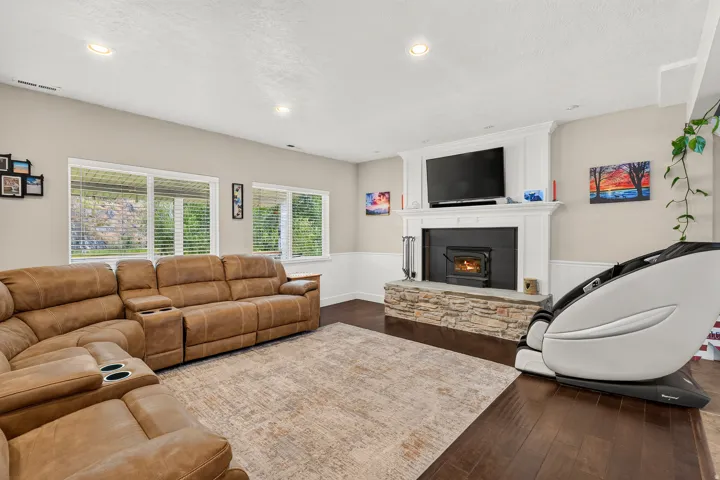 Living area featuring dark wood-finish flooring, recessed lighting, and multiple windows