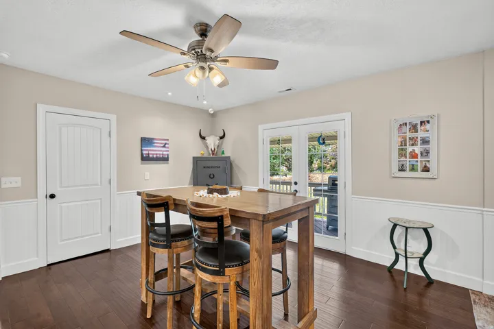 Hardwood-finish flooring complementing neutral wall tones and white wainscoting