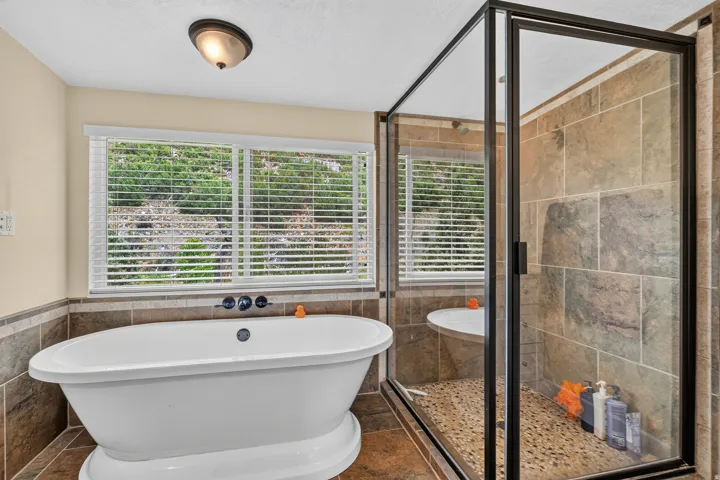 Freestanding soaking tub with a tiled surround