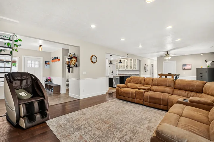 Spacious living area featuring dark wood-finish flooring, recessed lighting, and an open concept layout