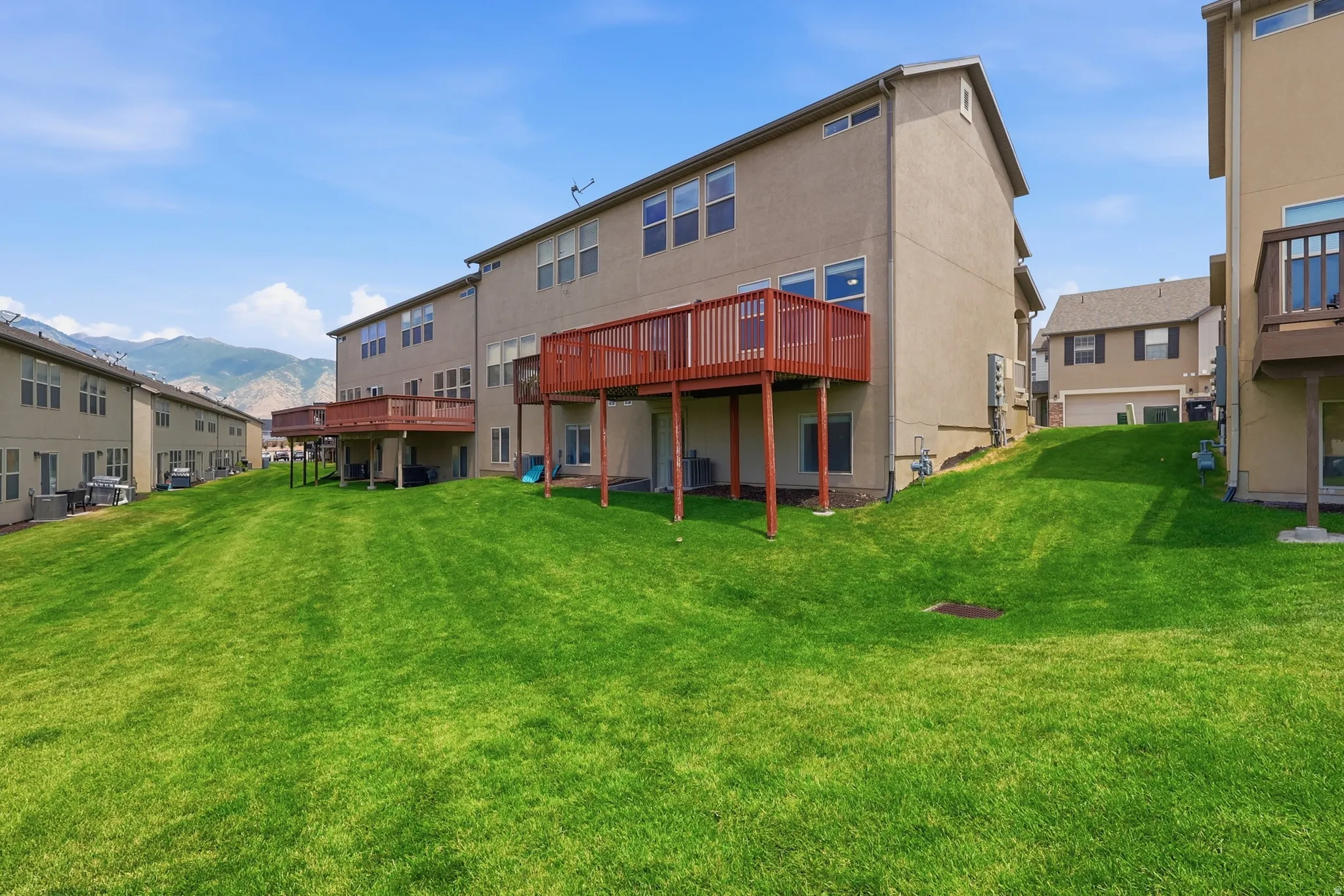 Expansive green lawn with mountain backdrop